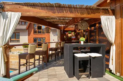 a patio with chairs and a table on a balcony at Ski & Spa Apartment S20 Milmari Resort Kopaonik in Kopaonik
