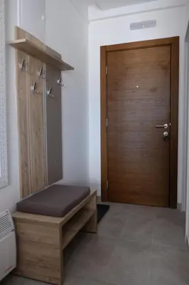 a room with a door and a bench and a door at Ski & Spa Apartment S20 Milmari Resort Kopaonik in Kopaonik