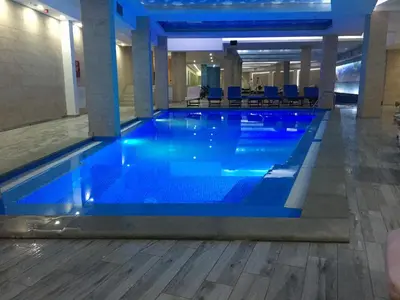 a large blue swimming pool in a building at Ski & Spa Apartment S20 Milmari Resort Kopaonik in Kopaonik