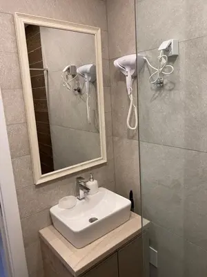 a bathroom with a sink and a mirror at Mount Apartments Milmari in Kopaonik