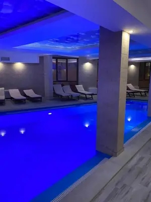 a swimming pool with blue lighting in a hotel at Mount Apartments Milmari in Kopaonik