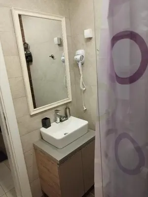 a bathroom with a sink and a mirror at Milmari-Apartman MARA L30 in Kopaonik