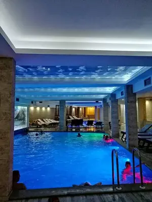 a pool in a hotel with people swimming in it at Milmari-Apartman MARA L30 in Kopaonik