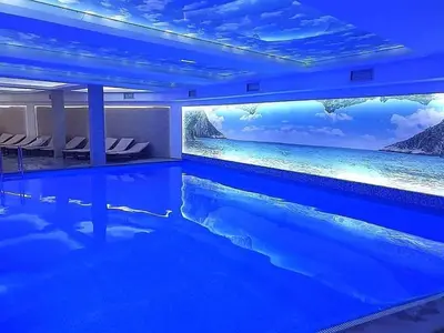 a large swimming pool with a painting of the ocean at TeonaLux Milmari Resort P84 in Kopaonik