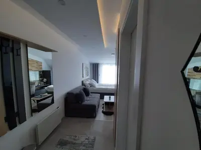 a living room with a couch and a bedroom at TeonaLux Milmari Resort P84 in Kopaonik