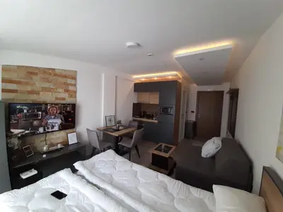 a bedroom with a bed and a living room at TeonaLux Milmari Resort P84 in Kopaonik