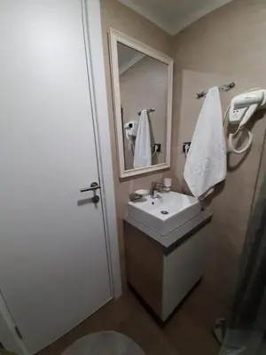 a bathroom with a sink and a mirror at TeonaLux Milmari Resort P84 in Kopaonik