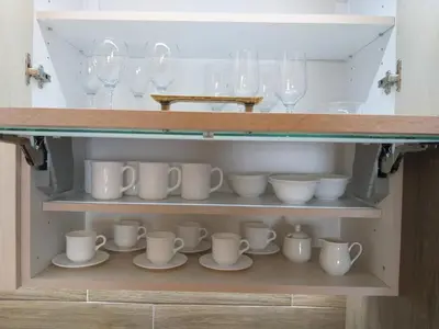 a cupboard with a bunch of cups and wine glasses at Milmari resort Sara P61 in Kopaonik