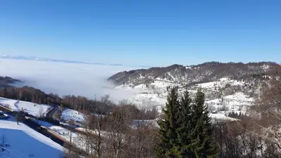 a view of a snow covered mountain with a lake at Milmari resort Sara P61 in Kopaonik