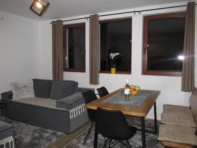 a living room with a couch and a table at JOPA Suncani breg in Kopaonik