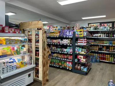a store aisle with shelves of food and drinks at JOPA Suncani breg in Kopaonik