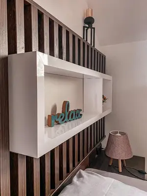 a shelf on the wall of a bedroom at Apartmani Džanković in Kopaonik