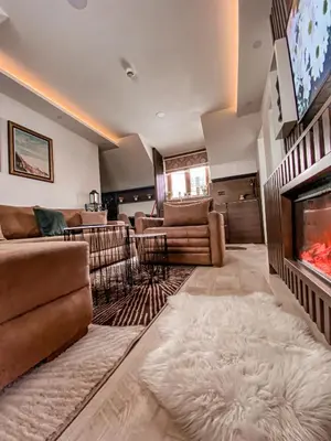 a living room with couches and a tv and a fireplace at Apartmani Džanković in Kopaonik