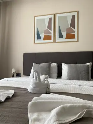 a bedroom with a large bed with towels on it at Apartmani Džanković in Kopaonik