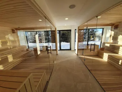 a large room with wooden stairs and a table at SUNCANI BREG - STUDIO 11 in Kopaonik