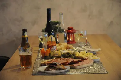 a table topped with plates of food and bottles of wine at SUNCANI BREG - STUDIO 11 in Kopaonik