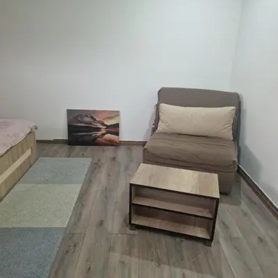 a living room with a couch and a coffee table at Square Apartment in Paraćin