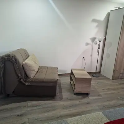 a living room with a couch and a table at Square Apartment in Paraćin
