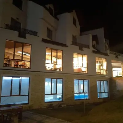 a large building with lit windows at night at Milmari Resort Maša S6 in Kopaonik
