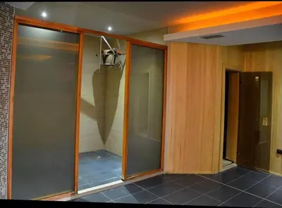 a walk in shower with glass doors in a room at Milmari Resort Maša S6 in Kopaonik