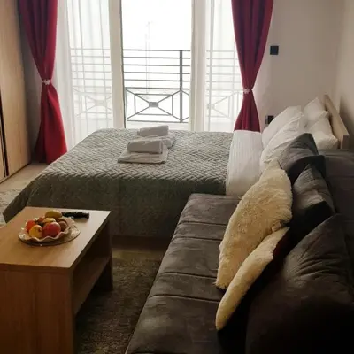 a living room with a couch and a table at Milmari Resort Maša S6 in Kopaonik