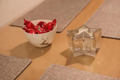 a bowl of red candy canes and a star on a table at Vila Pahulja A3 in Kopaonik