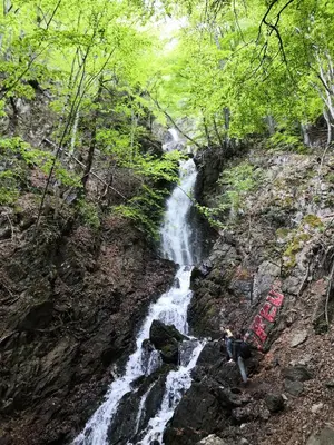 a person standing in front of a waterfall at Sky Cabin Apartments - FREE GARAGE in Kopaonik