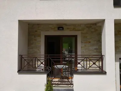 a balcony with tables and chairs on a building at Sky Cabin Apartments - FREE GARAGE in Kopaonik
