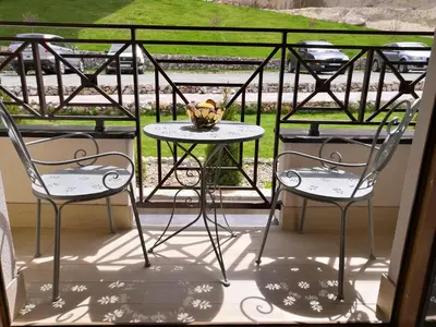 two chairs and a table on a balcony at Sky Cabin Apartments - FREE GARAGE in Kopaonik