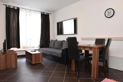 a living room with a couch and a table at Private apartman 5b23 in Kraljevi cardaci in Kopaonik