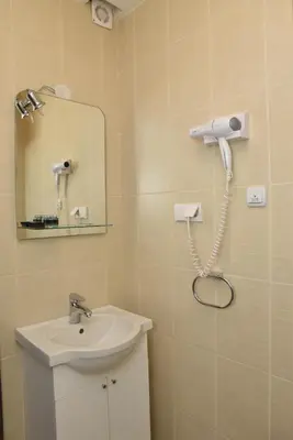a bathroom with a sink and a mirror at Private apartman 5b23 in Kraljevi cardaci in Kopaonik