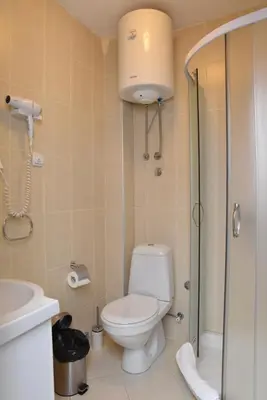 a bathroom with a toilet and a shower and a sink at Private apartman 5b23 in Kraljevi cardaci in Kopaonik