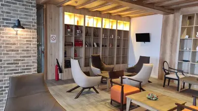 a restaurant with chairs and tables in a room at IN Apartman, Župa Kopaonik in Kopaonik