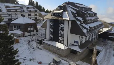 an aerial view of a building in the snow at IN Apartman, Župa Kopaonik in Kopaonik