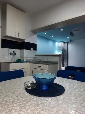 a blue bowl sitting on a table in a kitchen at Smeštaj Milenković in Soko Banja