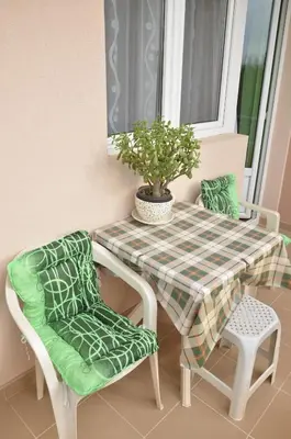a table and two chairs and a potted plant at Smeštaj Milenković in Soko Banja