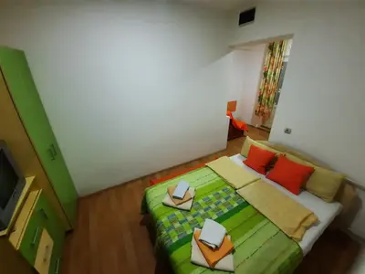 a bedroom with a bed with two books on it at Smeštaj Milenković in Soko Banja