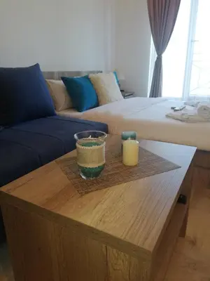 a living room with a table with two candles on it at Apartman Adelfes P16, Milmari Resort in Kopaonik