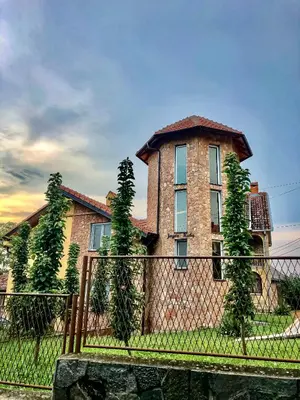 a brick house with a fence in front of it at Seosko turisticko domaćinstvo Jagor in Despotovac