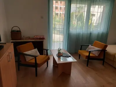 a living room with two chairs and a coffee table at Sokobanja Smeštaj Pavlović & privatan parking in Soko Banja