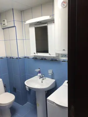 a blue and white bathroom with a sink and a toilet at Studio Mišel 2 in Vrnjačka Banja