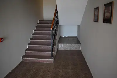 a staircase in a building with a stair case at Apartman G1 u Milmari kompleksu - Kopaonik in Kopaonik