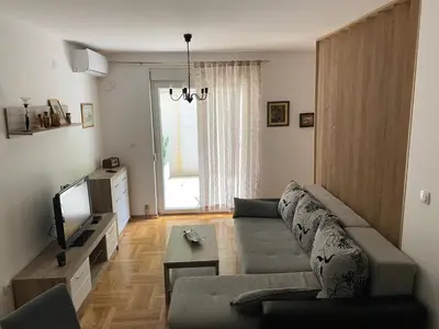 a living room with a couch and a tv at Apartmani CENTAR Vrnjacka Banja & Free Parking in Vrnjačka Banja