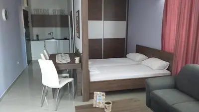 a small room with a bed and a table at Dream House in Kruševac