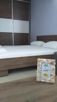 a bedroom with two beds and a sign on the floor at Dream House in Kruševac