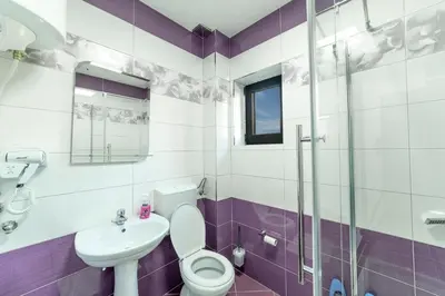 a bathroom with a toilet and a sink at Dream House in Kruševac
