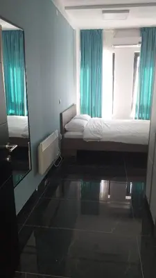 a hotel room with a bed and a mirror at Dream House in Kruševac