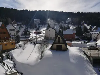 a small town covered in snow with houses at Vila Irina - Studio 15 lux in Kopaonik