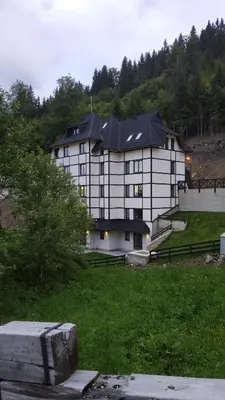 a large white building with a black roof at Vila Irina - Studio 15 lux in Kopaonik