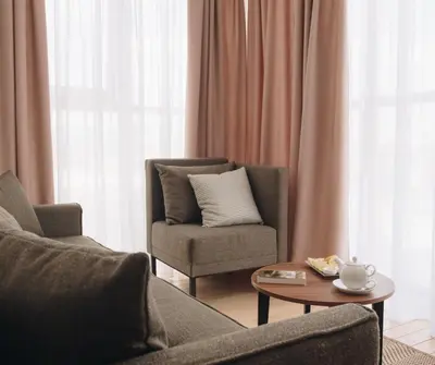 a living room with two chairs and a coffee table at Pegaz Holiday Resort in Vrnjačka Banja